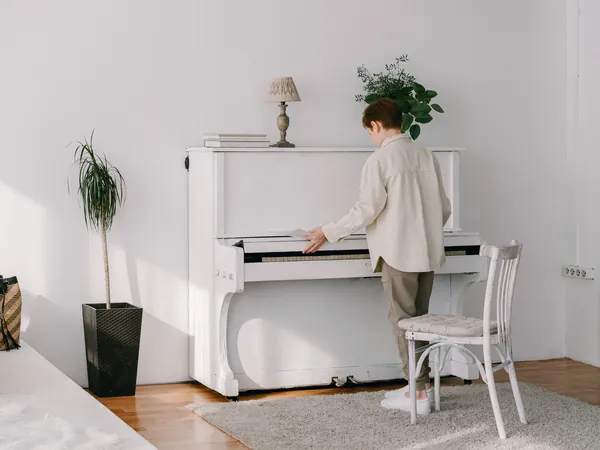 White upright piano in a bright living room